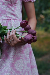 Midsection of woman holding plant