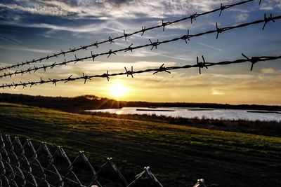 Chainlink fence at sunset