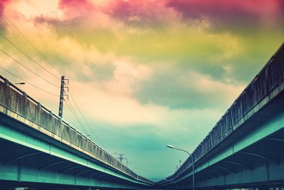 Low angle view of bridge against romantic sky during sunset