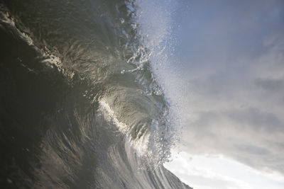 Water splashing in sea against sky