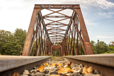 Low angle view of railroad bridge against sky