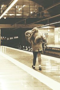 Full length of woman standing at railroad station