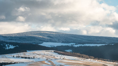 Hills with meadows and forest covered by snow, shot before sunset on orava region, slovakia, europe
