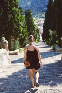 Rear view of woman walking on street