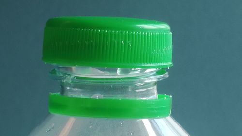 Close-up of green bottle on table