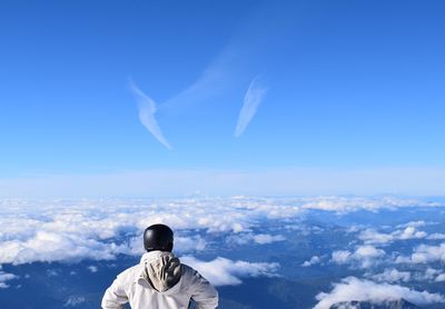 Rear view of man flying against sky