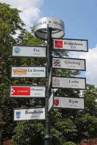 Low angle view of information sign against sky