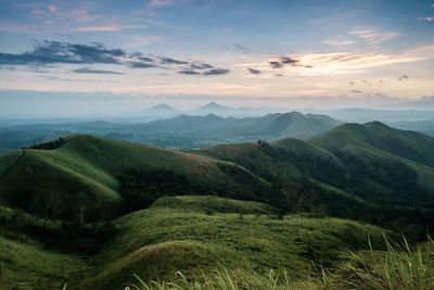 Scenic view of mountains against cloudy sky