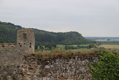 Old ruin on field against sky