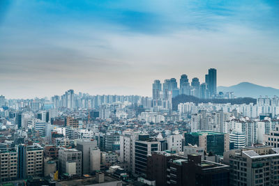 High angle view of buildings in city against sky