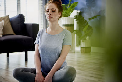 Young woman sitting at home