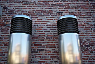 Low angle view of lamp mounted on brick wall