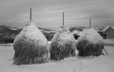 Panoramic shot of snow covered field against sky