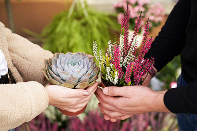 Midsection of woman holding plant