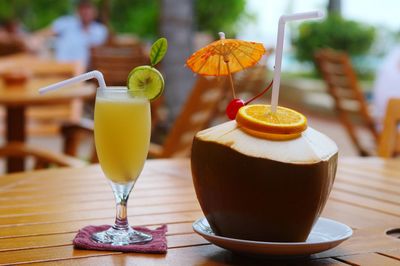 Drink and coconut served on table