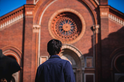 Rear view of man standing outside building