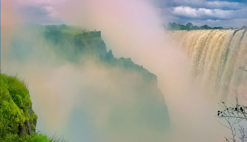 Scenic view of waterfall against sky