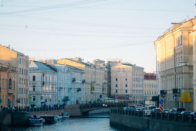 Canal amidst buildings against sky in city