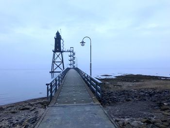 Pier over sea against sky