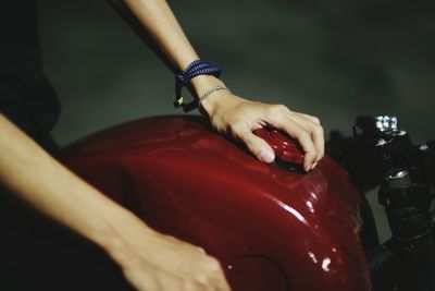 Cropped hands of person holding motorcycle