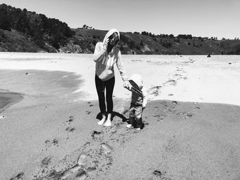 Mother standing with son at beach