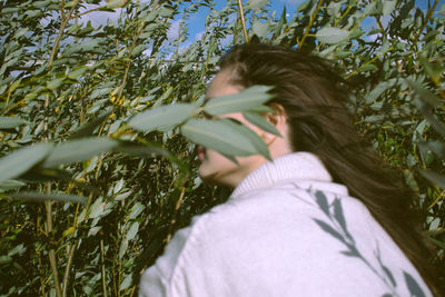 Close-up of woman by plants