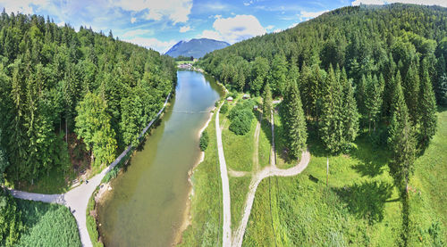 Panoramic shot of river amidst mountains against sky