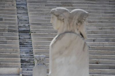 Statue against brick wall