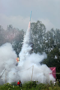 Crowd looking at rocket launch 