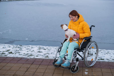 High angle view of woman with bicycle on snow