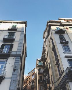 Low angle view of buildings against blue sky