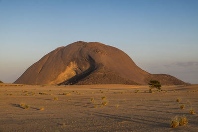 Low angle view of monolith ben amira at sunrise