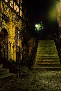 Street amidst illuminated buildings at night