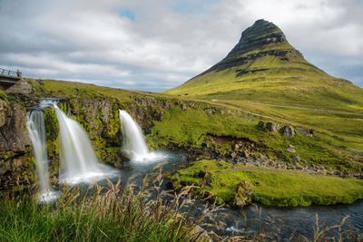 Scenic view of waterfall against sky