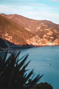 Scenic view of sea and mountains against sky