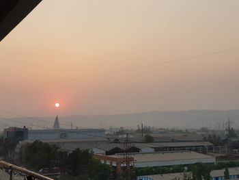 Cityscape against sky during sunset