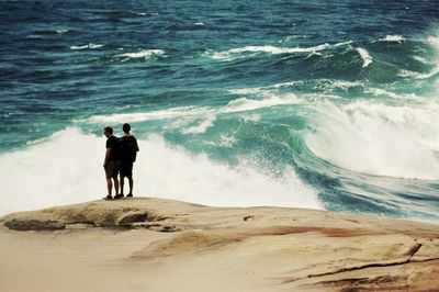 Rear view of men on beach