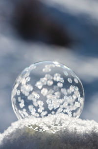 Close up image of soap bubble freezing in the snow on a winter's day.