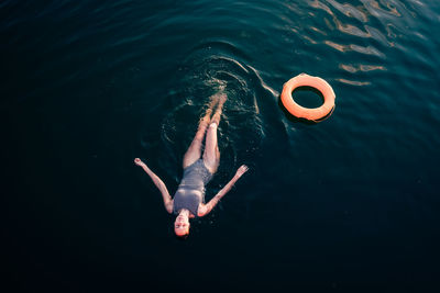 High angle view of woman swimming in sea