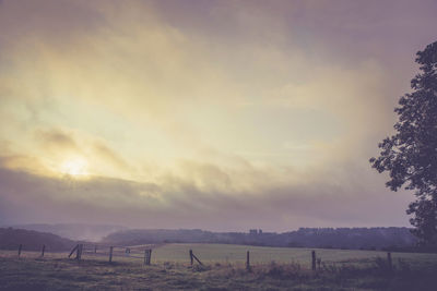 Scenic view of field against sky during sunset