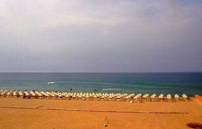 People on beach against clear sky