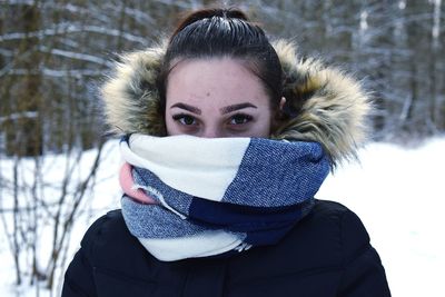 Close-up portrait of young woman in warm clothing during winter