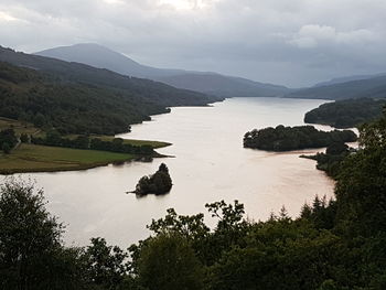 Scenic view of river and mountains against sky