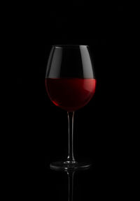 Close-up of wineglass against black background