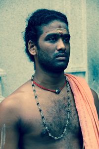 Shirtless sadhu looking away