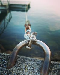 Close-up of metal chain on lake
