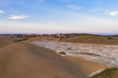 Drone aerial panorama of a desert like hill landscape with marble stones dust at sunset in terena
