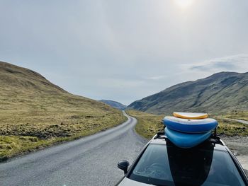 Road amidst mountains against sky