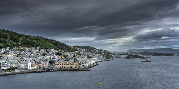 Scenic view of sea by buildings against sky