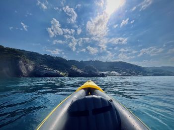 Cropped image of kayak in sea against sky